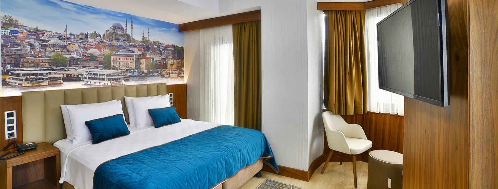 Double room at The Tango Hotel Taksim with an Istanbul skyline mural above the headboard